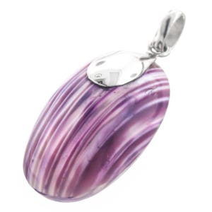 May include: A silver pendant with a purple and white striped shell. The shell is oval shaped and has a smooth, polished surface.