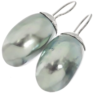 May include: A pair of silver earrings with large, oval-shaped, green Tahitian pearls.