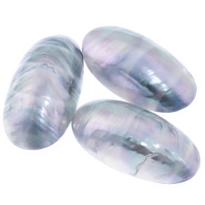 May include: Three iridescent, oval-shaped pearls with a lustrous, pearlescent sheen. The pearls display a range of colors, including silver, blue, and hints of green, against a white background. The smooth, elongated forms suggest a natural origin.