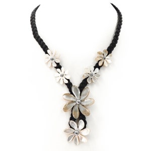 May include: A black braided cord necklace with white and beige shell flower accents. The necklace features five flowers, with a larger flower in the center.