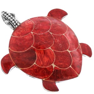 May include: A red turtle pendant with a silver head and a detailed shell design. The shell is made of red and white mosaic tiles.
