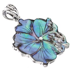 May include: A flower-shaped pendant featuring iridescent blue and green abalone shell inlay set within a polished silver frame. The pendant includes a decorative silver bail at the top, showcasing intricate metalwork and a natural shell texture.