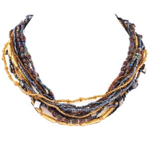 May include: Multi-strand necklace with brown, gold, and blue beads. The necklace is made of various sizes and shapes of beads, creating a layered and textured look.