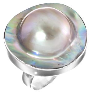Op de afbeelding: Een ring met een grote, ronde, iriserende mabe-parel gezet in een gladde, gepolijste zilverkleurige metalen band. De parel heeft een zacht, koepelvormig midden met een glanzend, veelkleurig oppervlak dat tinten roze, blauw en groen reflecteert.