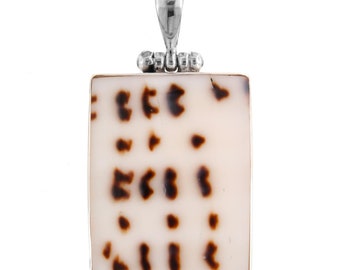 May include: A square pendant with a brown and white shell inlay. The pendant is made of silver and has a bail at the top for attaching a chain.