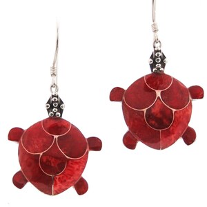 May include: A pair of silver earrings with red turtle shell designs. The turtles are made of red coral and have a silver accent on the top.