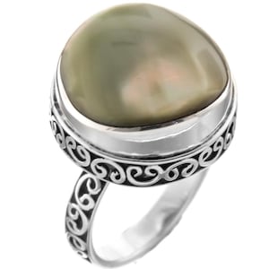 May include: A silver ring with a large, oval-shaped, green abalone shell set in a decorative, scroll-like band.