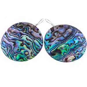 May include: A pair of circular earrings crafted from iridescent abalone shell, featuring swirling patterns of deep blue, vibrant green, and purple hues. Each earring is suspended from a thin, silver-toned metal hook for attachment to the ear.