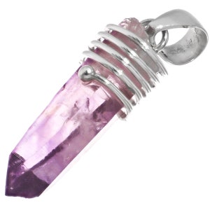 May include: A purple amethyst crystal point pendant with a silver wire wrap and a silver bail.