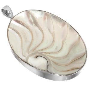 May include: A silver pendant featuring a white and cream iridescent shell with a swirling pattern. The pendant is oval shaped and has a silver bail.