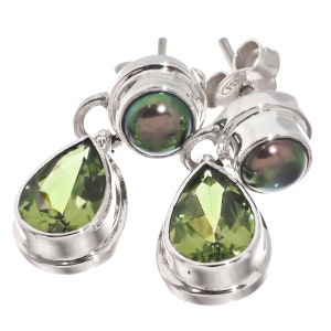 May include: Silver earrings with a pear-shaped green gemstone and a round black pearl. The earrings have a simple design and are perfect for everyday wear.