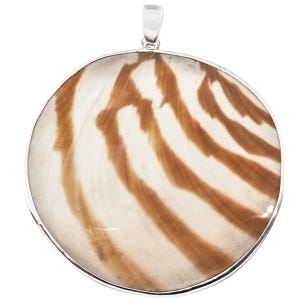 May include: A circular pendant featuring a polished, smooth stone with a white base and brown, sweeping, organic striped patterns. The stone is encased in a thin, polished silver-toned metal frame with a small, integrated silver-toned bail at the top.