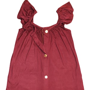 May include: A burgundy sleeveless dress with a round neckline and gold buttons down the front. The dress has short, ruffled sleeves.