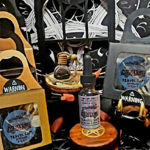 May include: A set of three car air fresheners with a vintage van design. The air fresheners are packaged in brown boxes with a warning label. The set also includes a bottle of essential oil with a dropper.