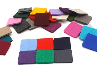 May include: A collection of square felt coasters in a wide variety of solid colors including red, blue, green, yellow, purple, pink, gray, black, and beige. The coasters are arranged in a loose pile with six pieces aligned in a grid.