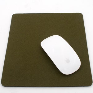 May include: A green felt mouse pad with a white wireless mouse on top.