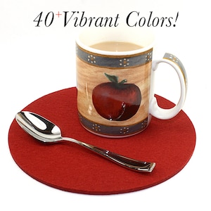 May include: A red felt coaster with a spoon and a coffee mug with an apple design. The mug has a light brown background with a gray band and white dots. The text "40+ Vibrant Colors!" is written in black above the mug.