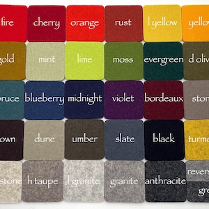 May include: A grid of thirty square felt coasters in various colors, each labeled with white text including fire, cherry, orange, rust, l yellow, yellow, gold, mint, lime, moss, evergreen, d olive, spruce, blueberry, midnight, violet, bordeaux, stone, brown, dune, umber, slate, black, turmeric, sandstone, h taupe, l granite, granite, anthracite, reversible, and grey.
