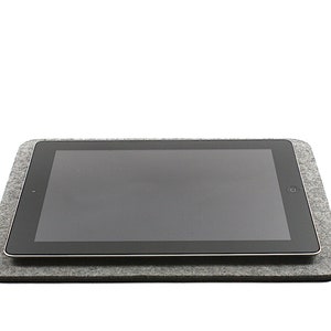 May include: A gray felt tablet stand with a black tablet resting on top.