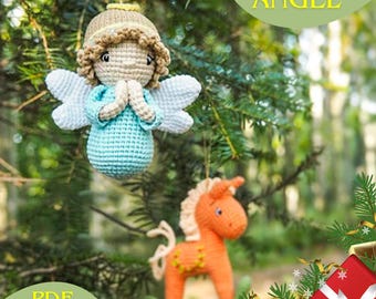 May include: A crochet Christmas angel ornament with a blue dress and white wings, hanging on a green pine tree branch. The angel is holding its hands together in prayer.  The text "CHRISTMAS ANGEL" is visible in the upper right corner of the image.  The text "PDF PATTERN" is visible in the lower left corner of the image.