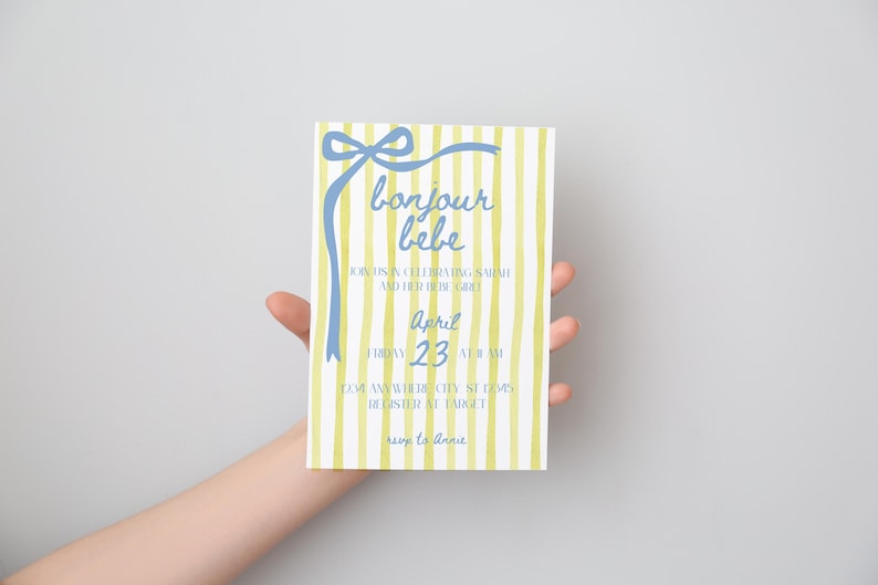 May include: A yellow and white striped baby shower invitation with a blue bow and the text "bonjour bebe". The invitation says "Join us in celebrating [name] and the arrival of the girl" and "April 23 at 11 am".