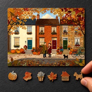 Peut inclure: Un puzzle rectangulaire représentant une scène de rue automnale avec trois maisons, deux personnes, un chien et des citrouilles. Sous l'image principale se trouvent six pièces de puzzle en bois en forme de citrouille, maison, arbre, feuille et chien.