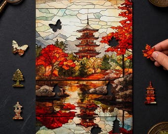 May include: A wooden jigsaw puzzle featuring a stained glass style illustration of a multi-tiered pagoda surrounded by vibrant red autumn trees and a reflective pond. The puzzle includes unique shaped pieces like a butterfly and a small pagoda.