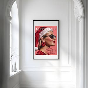 May include: A magazine cover featuring a woman wearing a red Santa hat and sunglasses. The cover reads "Queen Claus is she Naughty or Nice?"