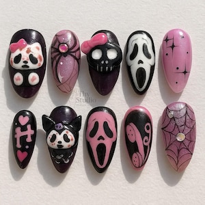 May include: A set of ten artificial nails with various Halloween-themed designs. The designs include a panda with a bow, a spider, a skull with a bow, a Scream mask, stars, hearts, a cat, a phone, and a spiderweb.