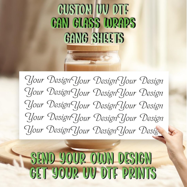 May include: A white card with the text "Your Design" repeated multiple times. The card is held in front of a glass jar with a brown liquid inside. The text "SEND YOUR OWN DESIGN GET YOUR UV DTF PRINTS" is written in green letters on a wooden surface below the jar.
