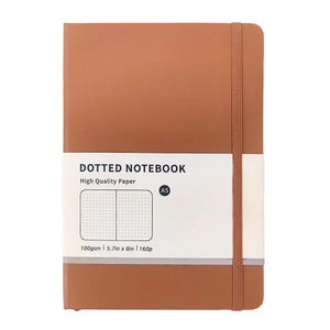 May include: A brown A5 dotted notebook with a white band featuring the text "DOTTED NOTEBOOK" and "High Quality Paper." The notebook has an elastic band closure. The paper is 5.7in x 8in and 160 pages.