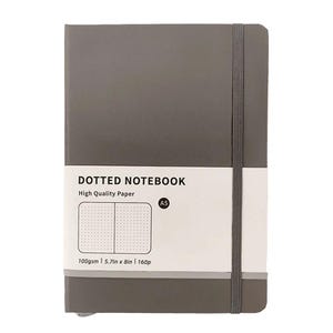 May include: A gray A5 dotted notebook with a white label that reads "DOTTED NOTEBOOK" and "High Quality Paper." The notebook has a gray elastic band and measures 5.7in x 8in.