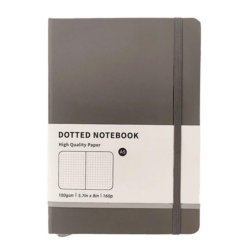 May include: A gray A5 dotted notebook with a white label that reads "DOTTED NOTEBOOK" and "High Quality Paper." The notebook has a gray elastic band and measures 5.7in x 8in.