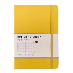 May include: A yellow A5 dotted notebook with a white band featuring the text "DOTTED NOTEBOOK" and "High Quality Paper." The notebook has a matching yellow elastic band closure. The notebook is 5.7in x 8in and 160 pages.