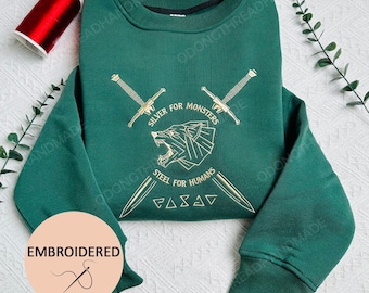The Witcher Besticktes Sweatshirt: Silber für Monster, Stahl für Menschen