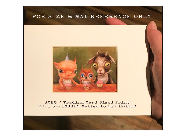 May include: A whimsical illustration of a pig, owl, and goat wearing party hats and holding cupcakes. The image is matted to 5x7 inches and measures 2.5 x 3.5 inches. ACEO / Trading Card Sized Print.