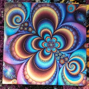 May include: A colorful abstract design with a blue, purple, and gold flower-like pattern. The design is intricate and detailed, with swirling lines and circles.