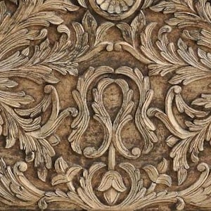 May include: A light brown wooden headboard featuring intricate hand-carved floral and scrolling leaf patterns across the entire surface. The top edge has a curved, arched silhouette with a central decorative motif and pointed finials on each side.