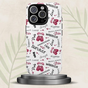 May include: White phone case with a repeating pattern of pink boxing gloves, hearts, and words like "Survivor," "Warrior," and "Hope." The case has a glossy finish and a camera cutout.