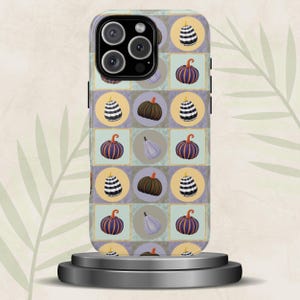 May include: A phone case with a repeating pattern of pumpkins and gourds. The design features orange, brown, and white pumpkins, and a pear-shaped gourd. The background is a mix of squares and circles in muted tones of green, purple, and yellow.