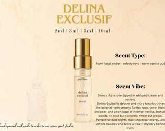 May include: A 5 ml bottle of Delina Exclusif perfume with a gold cap and a label that says "Delina Exclusif" and "Brand". The scent type is described as "fruity floral amber, velvety rose, warm vanilla oud". The scent vibe is described as "Smells like a rose dipped in whipped cream and secrets. Delina Exclusif is deeper and more luxurious than the original - with creamy Turkish rose, sweet litchi and pear, and a rich base of incense, vanilla, and soft woods. It's bold but romantic, sweet but grown. Perfect for date nights, main character energy, and soft life baddies who leave a trail of mystery behind them."
