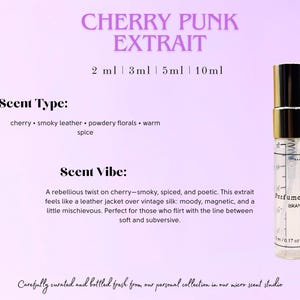 May include: A perfume bottle with a gold cap and a clear glass body, labelled "Cherry Punk Extrait." The label lists scent notes of cherry, smoky leather, powdery florals, and warm spice. The text also describes the scent as moody and magnetic.