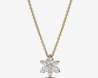 May include: A gold-colored necklace featuring a flower-shaped pendant. The pendant is adorned with clear, sparkling gemstones arranged in a floral pattern. The necklace has a delicate chain.