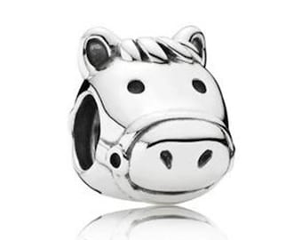 May include: A silver horse head charm. The charm has a detailed design, including a bridle and dark eye and nostril details. This horse charm is a jewelry accessory, suitable for a bracelet or necklace.