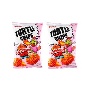 May include: Two bags of Orion Turtle Chips, a flavored snack. The bags are pink and white, with the words "Turtle Chips" in large black letters. The bags feature a cartoon turtle character breathing fire and the words "Carbonara Hot Chicken".
