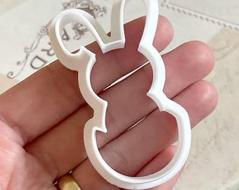 May include: White plastic cookie cutter shaped like a bunny rabbit.