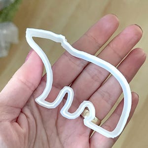 May include: White plastic cookie cutter shaped like a polar bear.