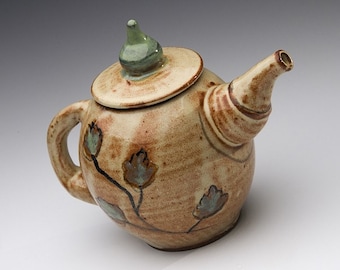 Handmade pottery teapot with painted leaves