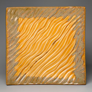 May include: Square ceramic plate with a textured, wavy design in shades of yellow and brown.