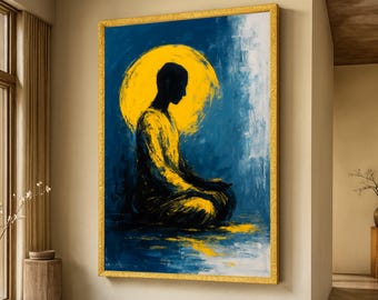 May include: Abstract painting of a meditating figure in yellow and black against a blue background, with a yellow halo. The artwork is framed in a gold-colored frame, creating a striking contrast. The painting is displayed on a beige wall.